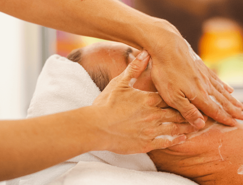 Relaxing spa facial massage in progress