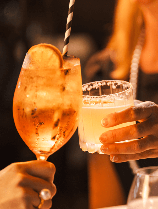 Two cocktails held in hands